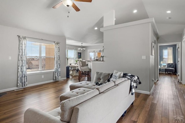 living room with lofted ceiling, wood-type flooring, baseboards, and ceiling fan with notable chandelier