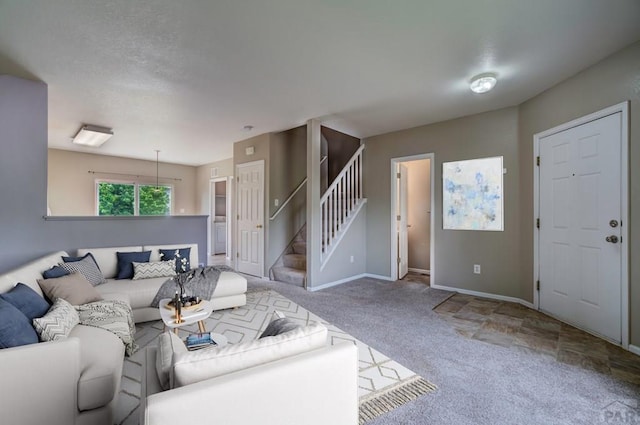 6292 Riverdale Dr, Colorado Springs, CO 80923 - carpeted living room with stairs and baseboards