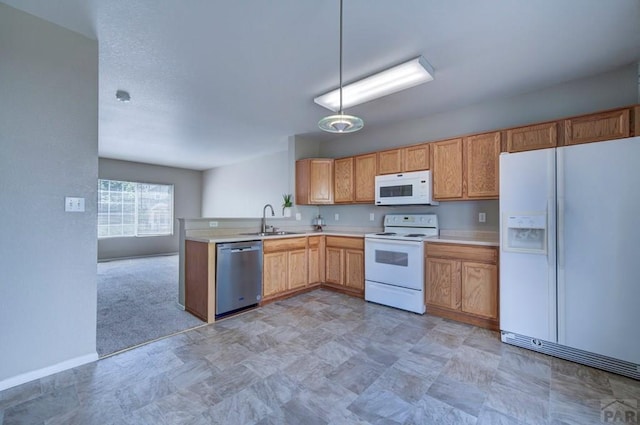 6292 Riverdale Dr, Colorado Springs, CO 80923 - kitchen featuring white appliances, light countertops, hanging light fixtures, and a peninsula