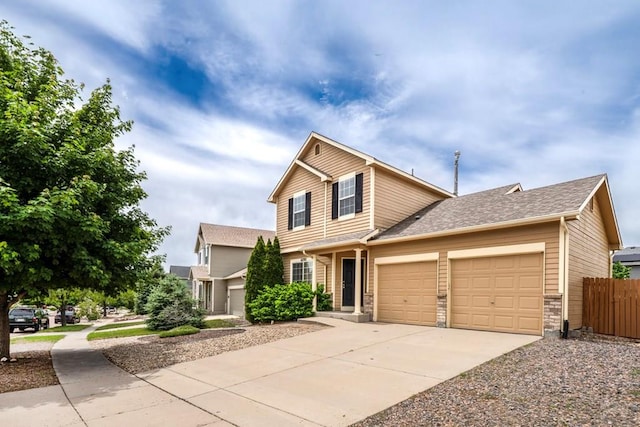 6292 Riverdale Dr, Colorado Springs, CO 80923 - traditional home with driveway, an attached garage, and a shingled roof