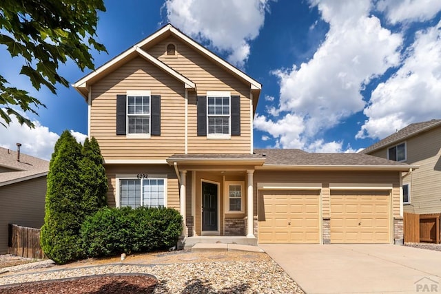 6292 Riverdale Dr, Colorado Springs, CO 80923 - view of front facade featuring an attached garage and concrete driveway