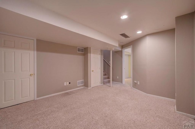 6292 Riverdale Dr, Colorado Springs, CO 80923 - finished basement with light colored carpet, stairway, and recessed lighting