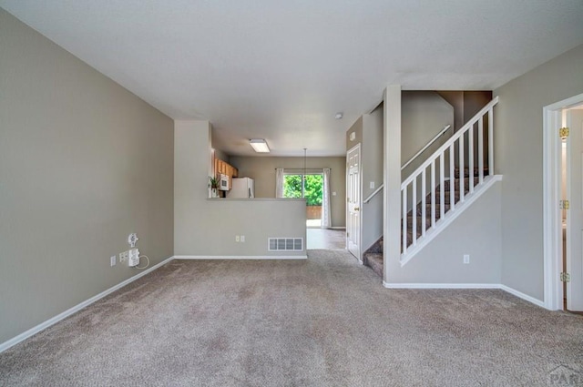 6292 Riverdale Dr, Colorado Springs, CO 80923 - unfurnished living room featuring carpet floors and stairway