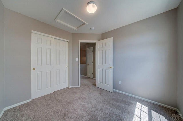 6292 Riverdale Dr, Colorado Springs, CO 80923 - unfurnished bedroom featuring attic access, carpet floors, and a closet