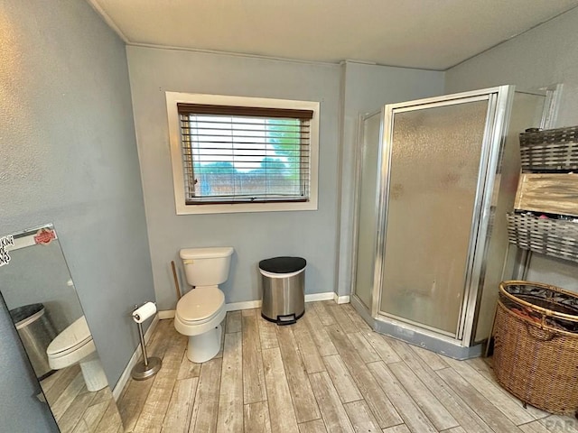 2 Kincaid Dr, Swink, CO 81077 - bathroom featuring wood finished floors, toilet, and a shower stall