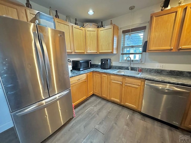 2 Kincaid Dr, Swink, CO 81077 - kitchen featuring appliances with stainless steel finishes, a sink, light wood-style floors, dark countertops, and recessed lighting