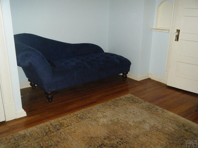 sitting room featuring baseboards and wood finished floors