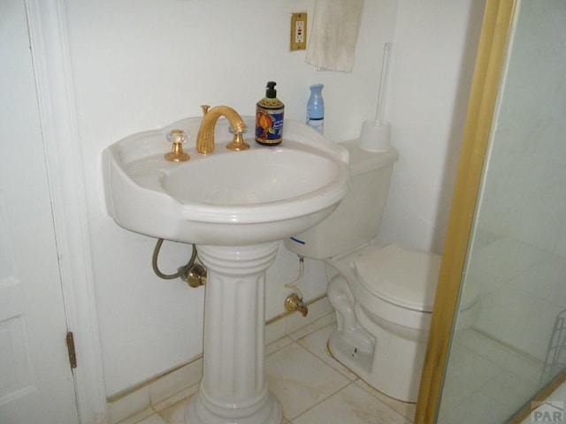 bathroom with tile patterned flooring and toilet