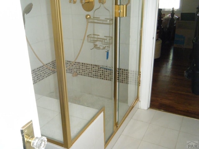 bathroom with tile patterned floors and a shower stall
