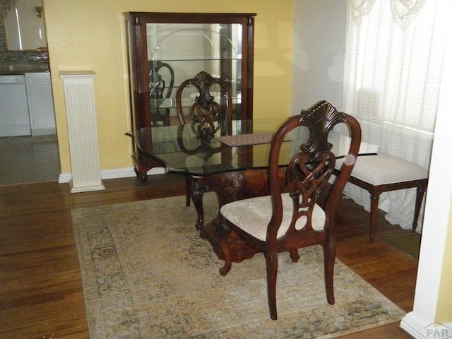 dining room with baseboards and wood finished floors