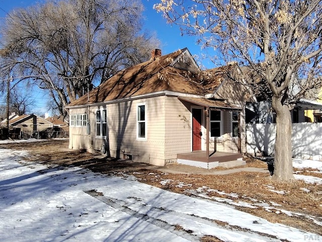 view of front of property with fence and a chimney