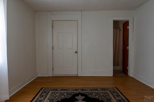 interior space featuring baseboards and light wood-style floors