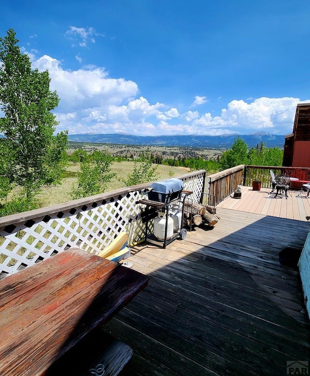 997 Wells Fargo Cir, Jefferson, CO 80456 - wooden deck featuring area for grilling and outdoor dining area