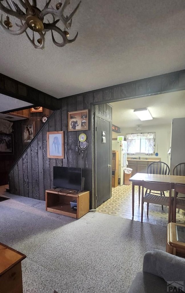 997 Wells Fargo Cir, Jefferson, CO 80456 - living room featuring stairway, wood walls, a textured ceiling, and a ceiling fan