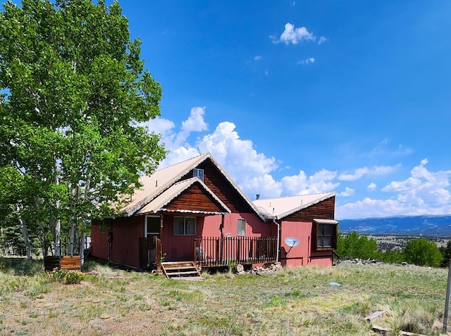 997 Wells Fargo Cir, Jefferson, CO 80456 - rear view of property with a wooden deck and a metal roof