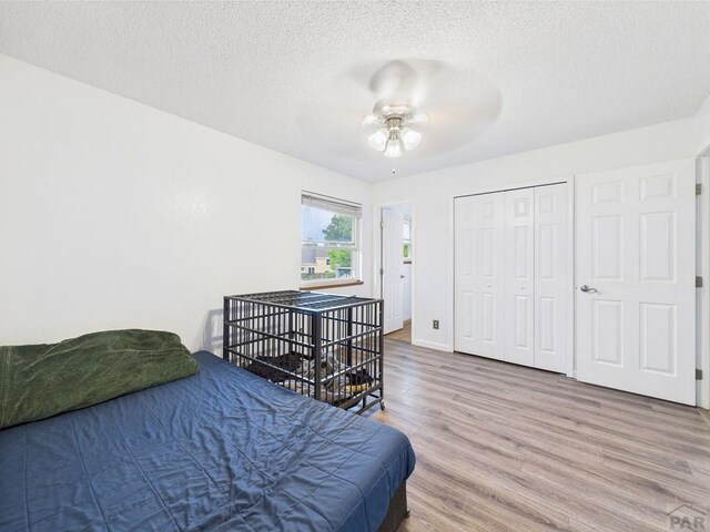 1018 Rancher Dr, Fountain, CO 80817 - bedroom with wood finished floors, a textured ceiling, a closet, and a ceiling fan