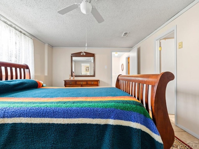 1505 Center Ln, Pueblo, CO 81006 - bedroom featuring tile patterned floors, ceiling fan, ornamental molding, and a textured ceiling