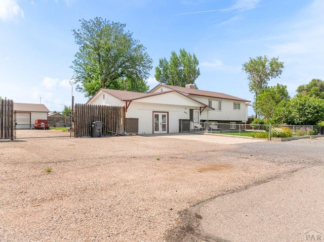 1505 Center Ln, Pueblo, CO 81006 - view of front facade with french doors and a gate