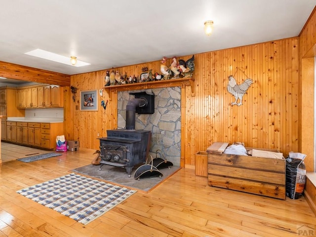 1505 Center Ln, Pueblo, CO 81006 - living area with light wood finished floors, wooden walls, and a wood stove