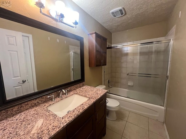 full bathroom with shower / bath combination with glass door, visible vents, toilet, a textured ceiling, and tile patterned floors