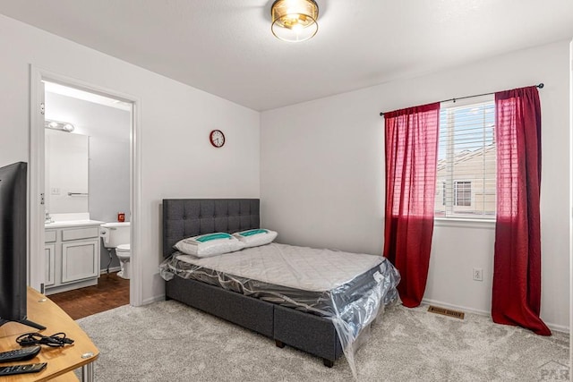 4141 Outlook Blvd Unit Q, Pueblo, CO 81008 - carpeted bedroom with ensuite bathroom and baseboards