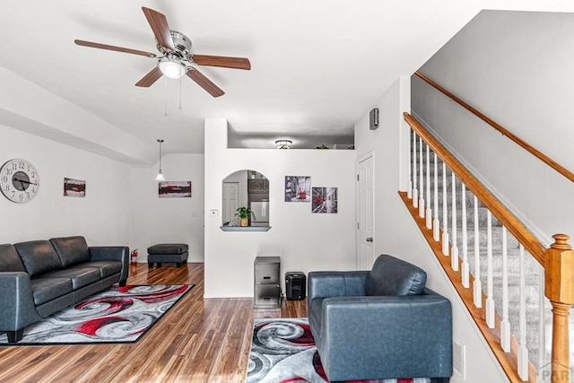 4141 Outlook Blvd Unit Q, Pueblo, CO 81008 - living room featuring wood finished floors, ceiling fan, and stairway