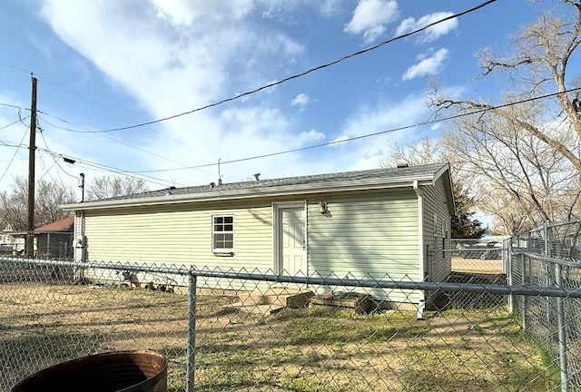 view of property exterior with fence and roof with shingles
