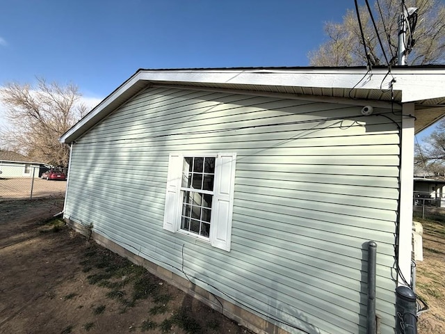 view of property exterior featuring fence