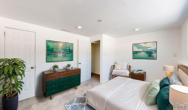 bedroom with recessed lighting, visible vents, and light carpet