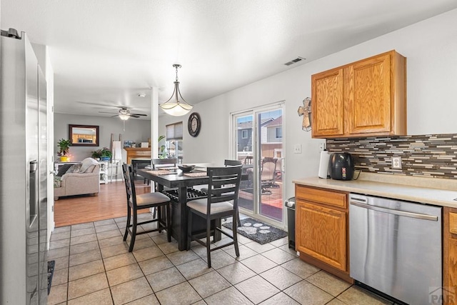 dining area with ceiling fan, light tile patterned flooring, and visible vents