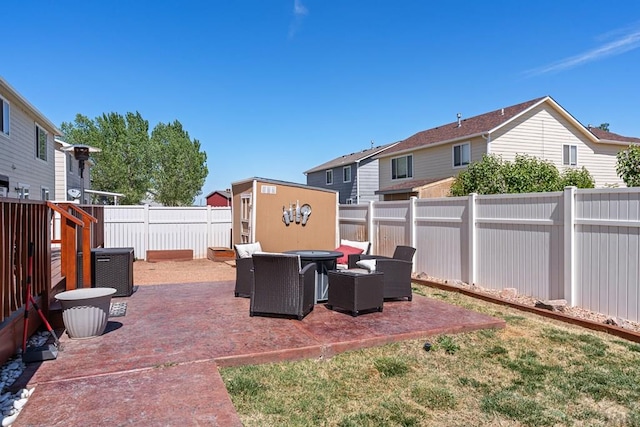 view of patio / terrace featuring a fenced backyard, an outbuilding, a storage shed, and cooling unit
