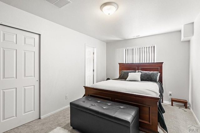 carpeted bedroom with visible vents and baseboards
