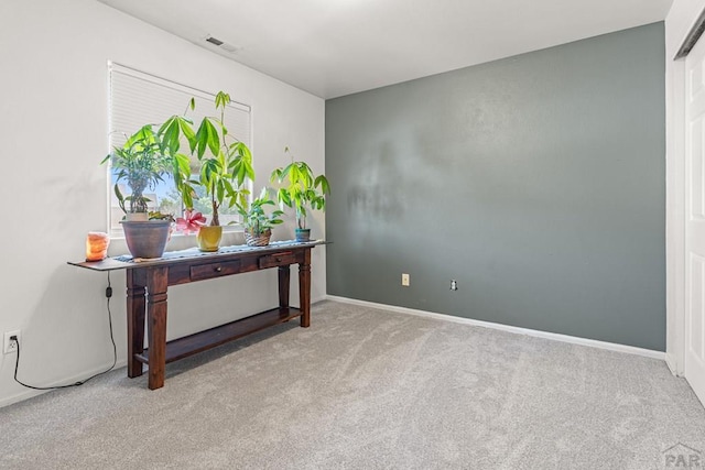 interior space featuring carpet floors, baseboards, and visible vents