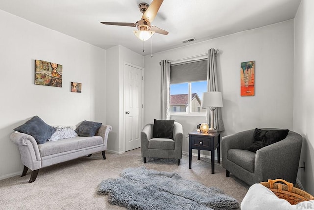 sitting room with visible vents, carpet, ceiling fan, and baseboards