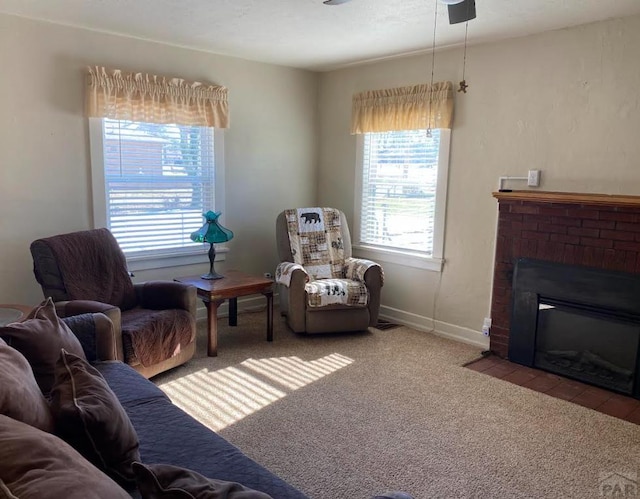 living room with light carpet, a brick fireplace, and baseboards