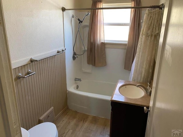 full bathroom with toilet, shower / bath combination with curtain, wood finished floors, and vanity