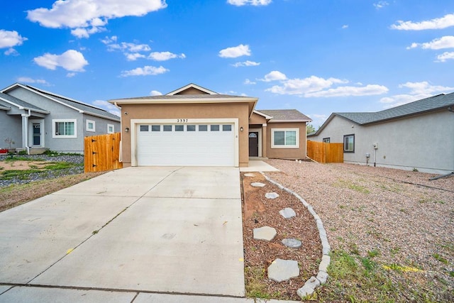 2337 Cruz Ct, Pueblo, CO 81003 - ranch-style house featuring stucco siding, a garage, fence, and driveway