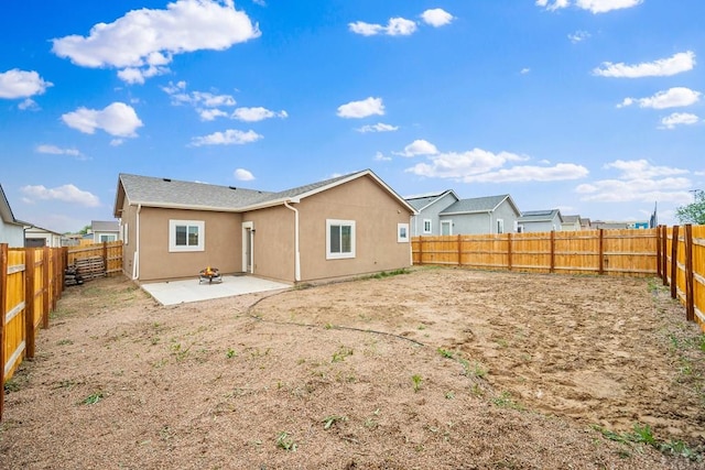 2337 Cruz Ct, Pueblo, CO 81003 - back of property featuring stucco siding, a patio, and a fenced backyard