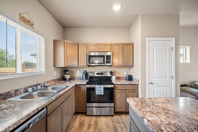 2337 Cruz Ct, Pueblo, CO 81003 - kitchen with appliances with stainless steel finishes, a sink, light wood-style flooring, and healthy amount of natural light