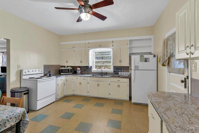 kitchen with white appliances, ceiling fan, light countertops, light floors, and a sink