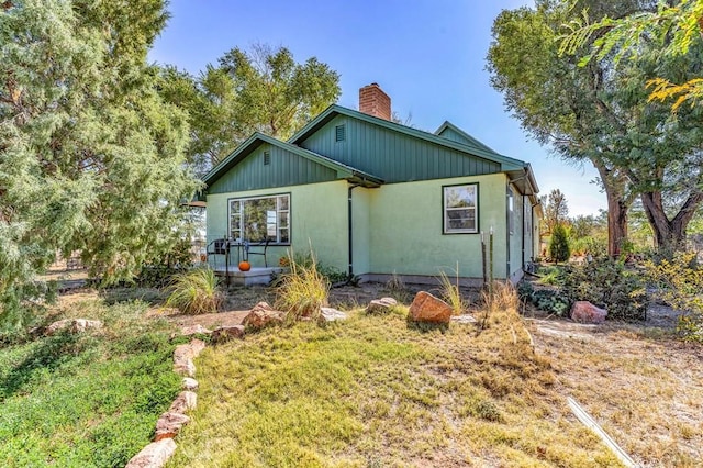 view of front of property with a chimney and a front yard