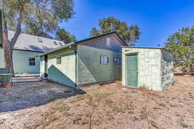 back of property featuring stucco siding