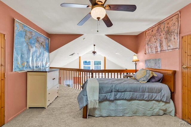 bedroom featuring light carpet, vaulted ceiling, and a ceiling fan