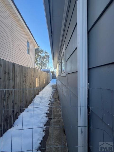 view of side of home featuring fence