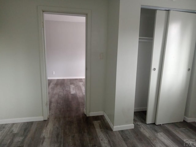 interior space with dark wood-style floors and baseboards