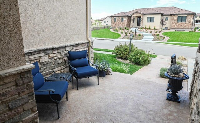 view of patio / terrace featuring a residential view and fence