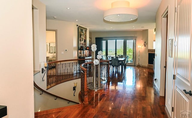 hall with baseboards, wood finished floors, and recessed lighting