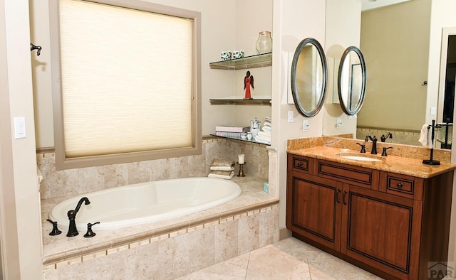 full bath with tile patterned flooring, a garden tub, and vanity