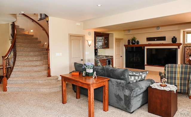 living room with wine cooler, recessed lighting, light carpet, stairway, and indoor wet bar