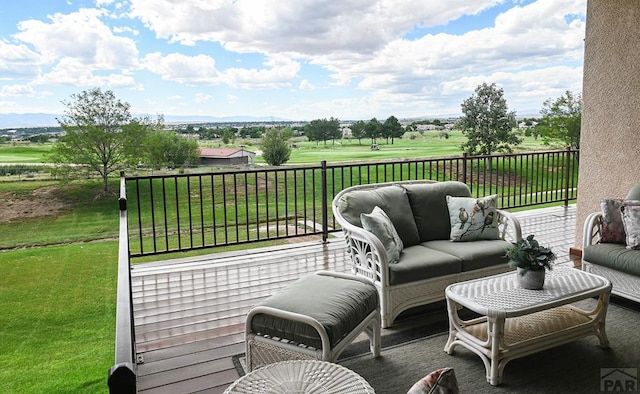 wooden terrace with a lawn